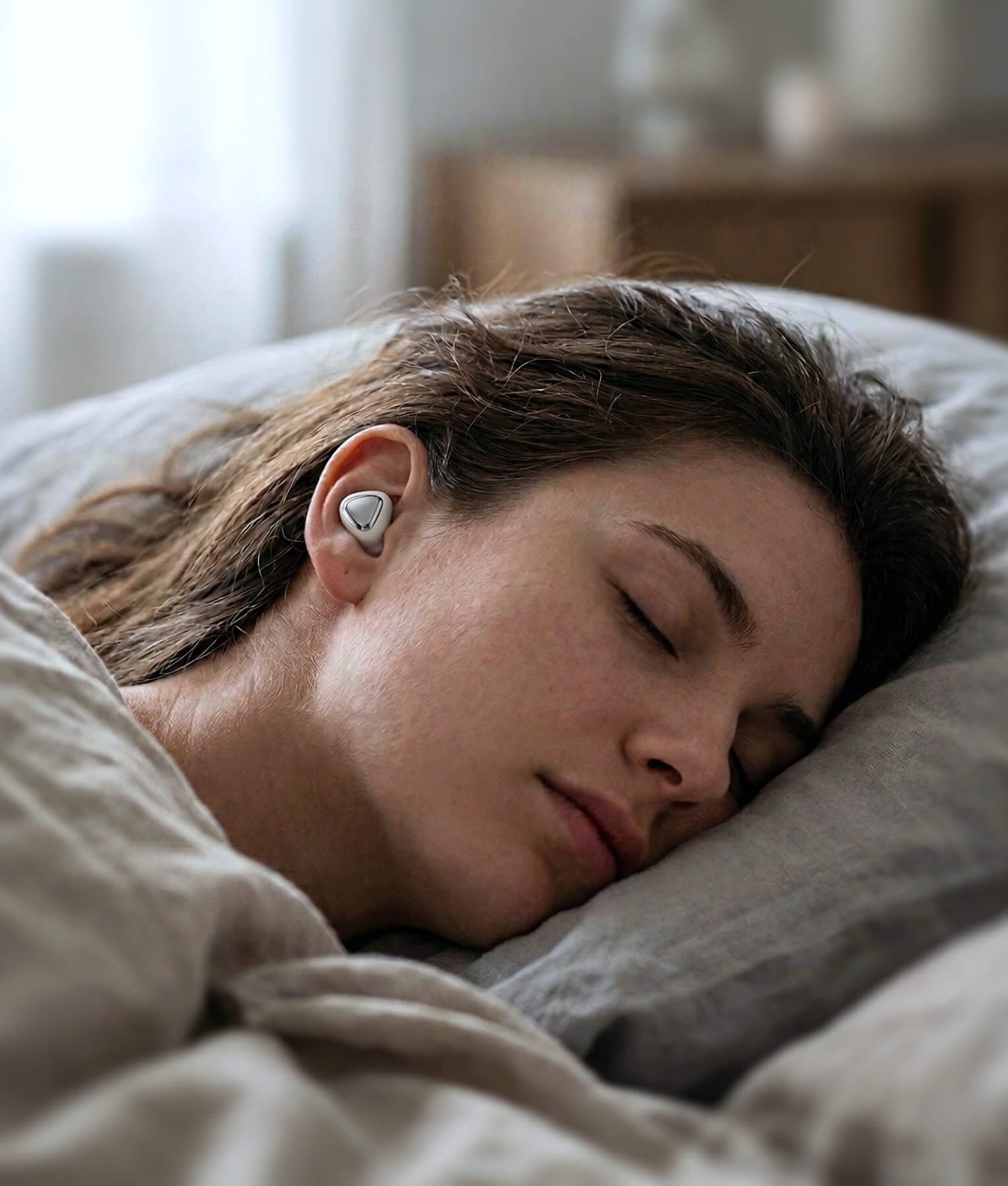 Woman sleeping with white earplugs