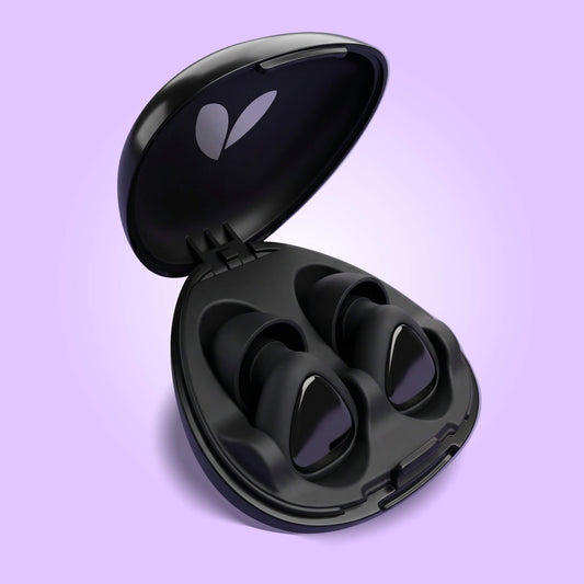 Black earplugs in an open case on a purple background